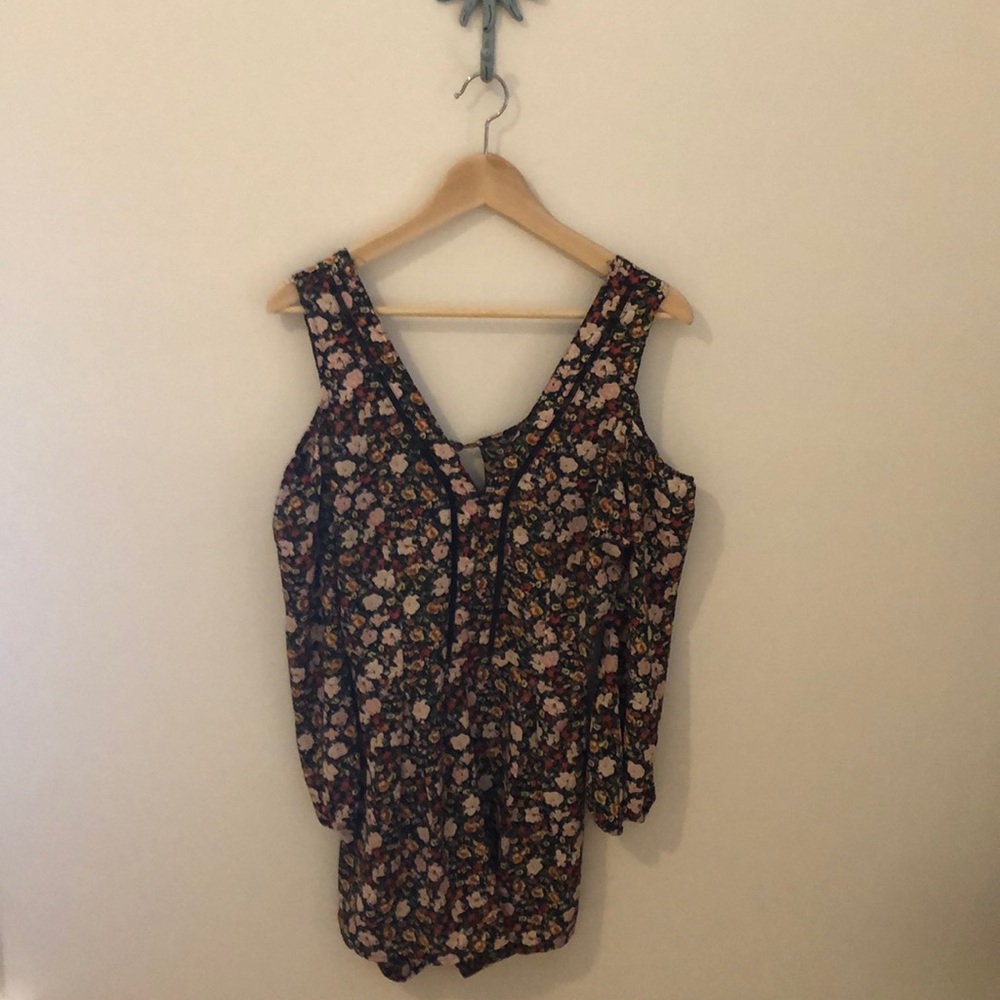 Flirty and fun cold shoulder open back romper!